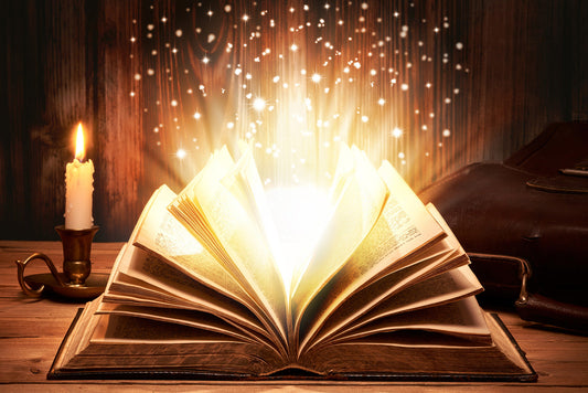 fantasy book open on a table with candle