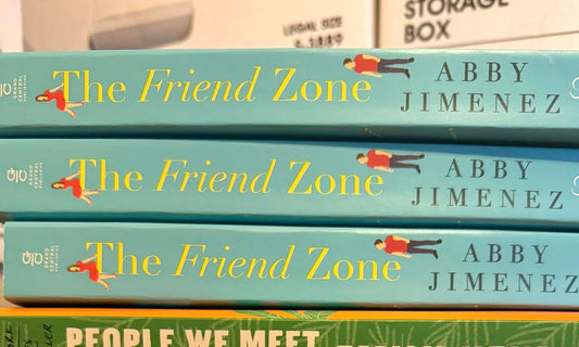 The Friend Zone by Abby Jimenez book stack