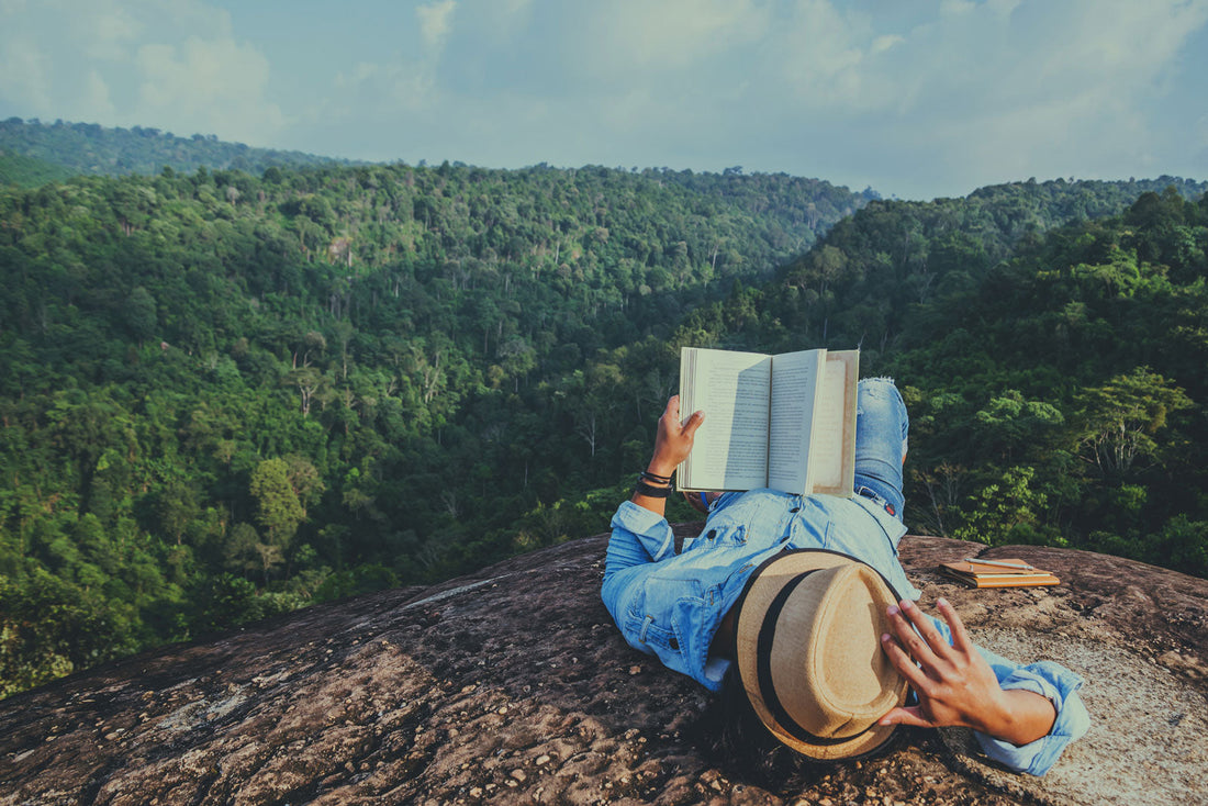 Person reading on a mountain