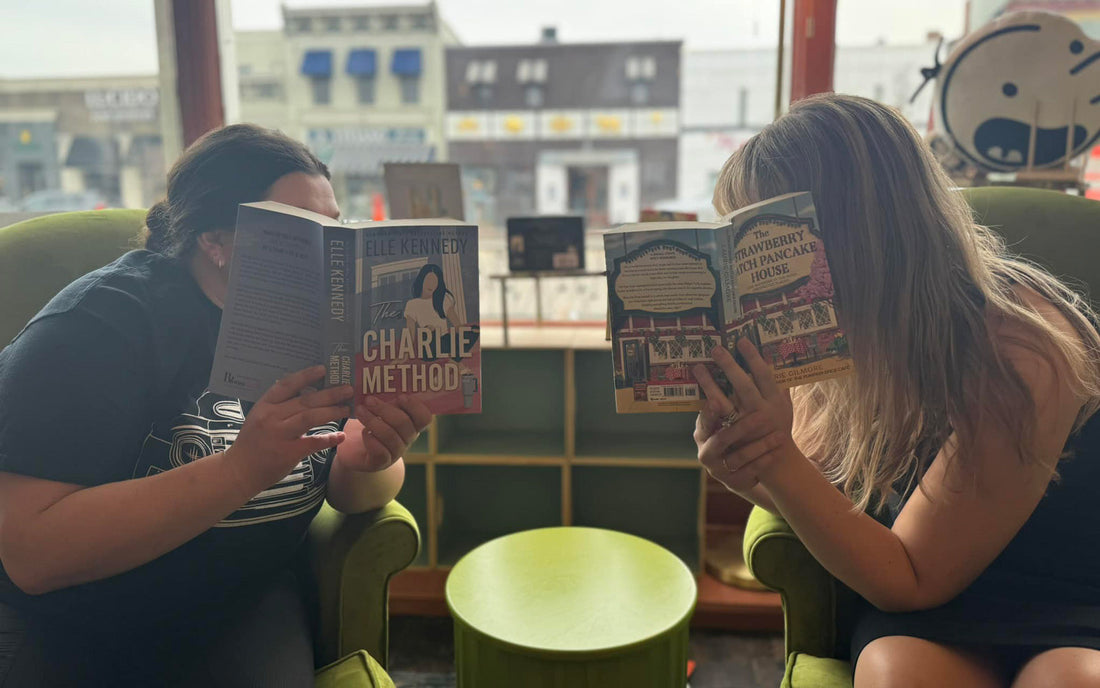 Two women hide behind their books to illustrate Silent Book Club in Rochester, MI