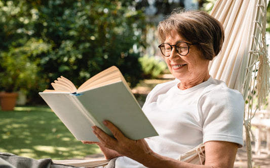 Woman enjoys a summer book release in a hammock