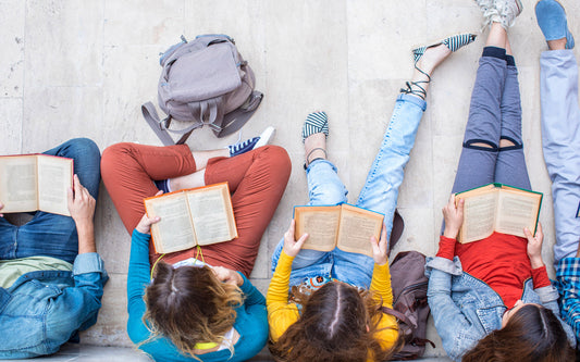Young adults reading outside of school