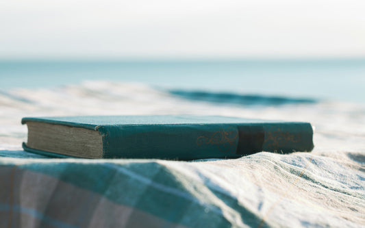 A book outside on a blanket