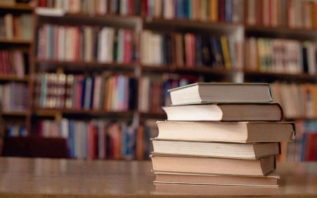 Stack of biographies on a table in a bookstore