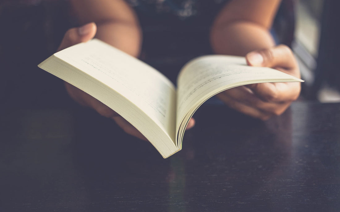 Person holding open book