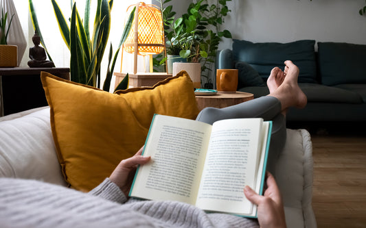 Woman reads thriller book on the couch