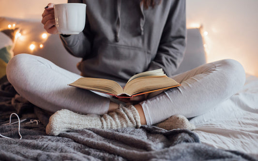 Woman reading a book during the holidays with coffee